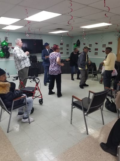 Residents enjoying a celebration in a common area