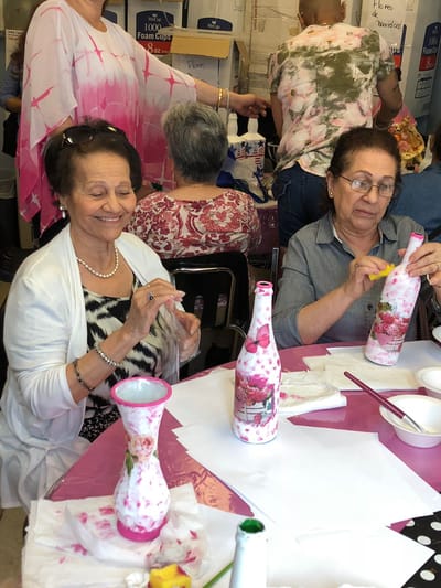 Residents engaged in a crafting activity at a communal table