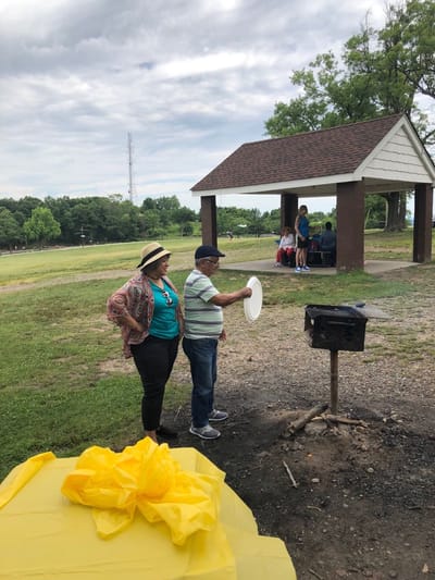 Residents enjoying an outdoor barbecue in a park setting