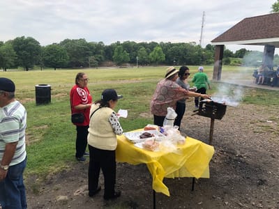 Residents enjoying a barbecue in a park setting