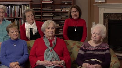 Residents engaging in conversation in a cozy living room
