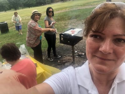 Staff and residents enjoying a barbecue outdoors