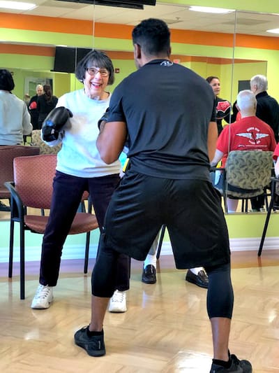 Residents engaging in a boxing exercise class