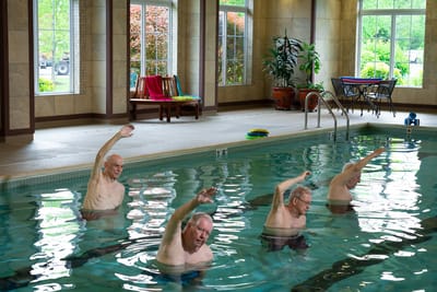 Seniors participating in a pool exercise class