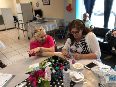 Residents enjoying a nail painting activity in common area