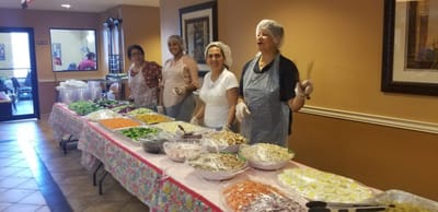 Staff serving food in a common area