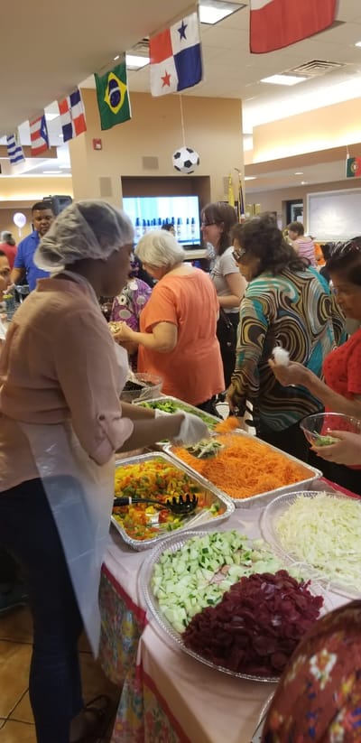 Residents enjoying a cooking activity with fresh ingredients