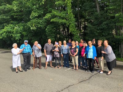 Group of smiling residents enjoying time together outdoors