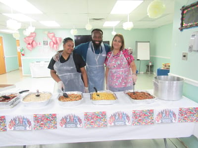 Staff serving food at a resident activity event