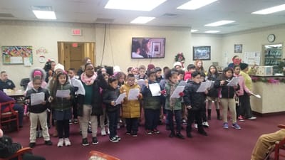 Children performing in a common area of the facility