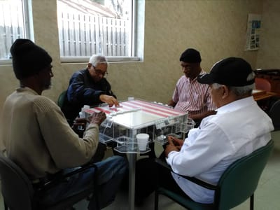 Residents engaging in a game around a table