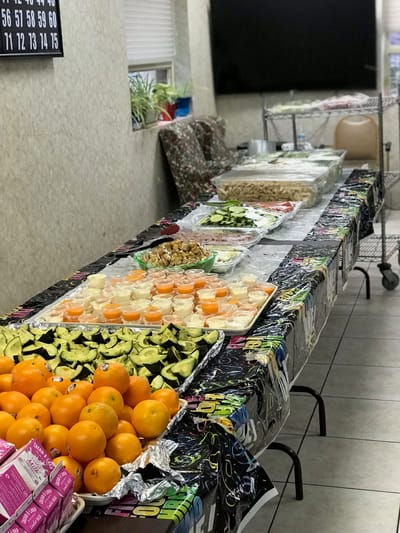 A table filled with assorted food items and fruits