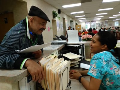Staff member interacting with a resident in a lobby area