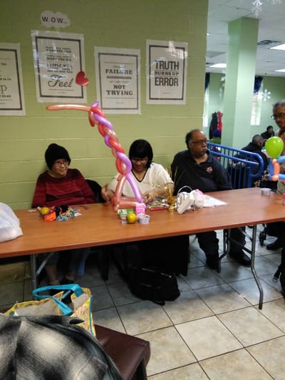 Residents and staff enjoying a balloon activity in a common area