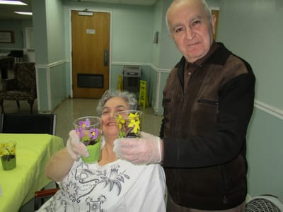 Residents holding flower pots during an activity