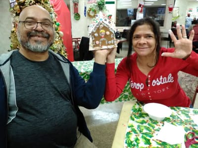 Residents enjoying a holiday activity with a gingerbread house
