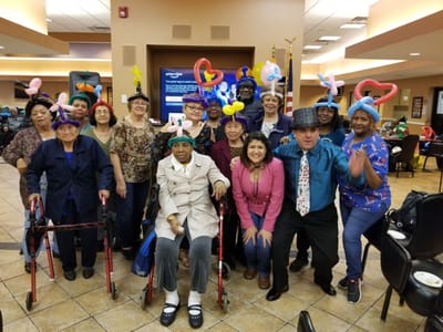 Residents and staff enjoying a celebration with balloons