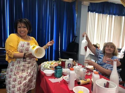 Residents enjoying a craft activity at a social table