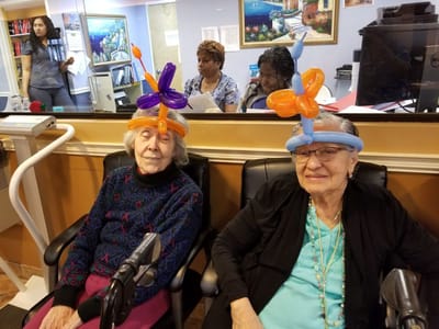 Residents enjoying balloon activities in a common area