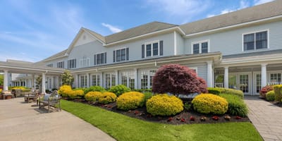 Exterior view of a senior living facility with landscaped gardens