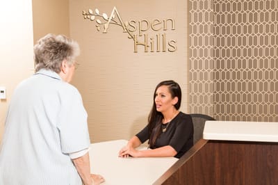 Staff member assisting a resident at reception