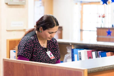 Staff member working at the reception desk