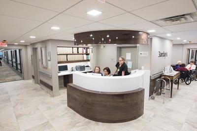 Reception area with staff and residents interacting