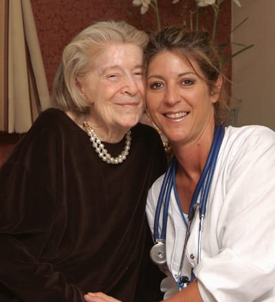 Caregiver and resident sharing a joyful moment