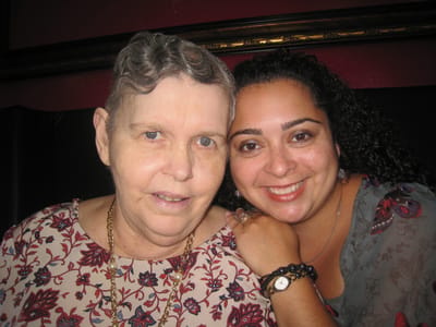 Resident and staff member smiling together