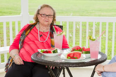 Resident enjoying refreshments on a patio