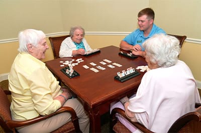 Residents and staff playing a game in a common area