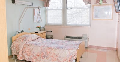 Bright and cozy resident room with hospital bed