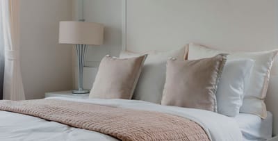 Comfortable bedroom with soft bedding and decor