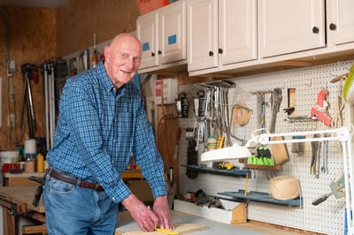 An elderly man working in a workshop