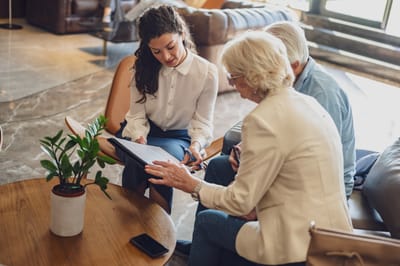 A staff member discussing with two residents in a lounge area