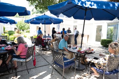 Residents enjoying time in the outdoor space with umbrellas