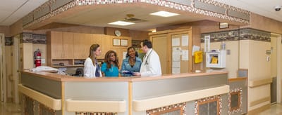 Staff interacting at a reception area in the facility