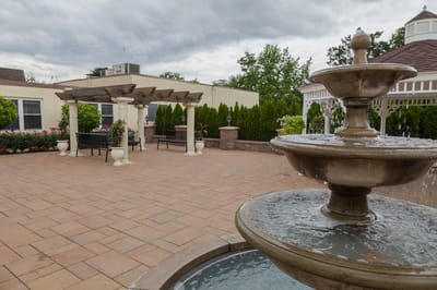 Outdoor patio area with a fountain and seating