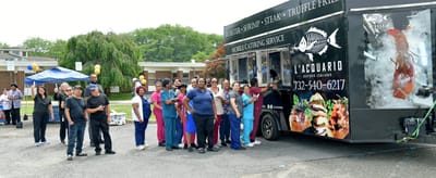 Staff and residents enjoying food from a food truck