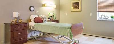 A private resident room with a hospital bed and decor