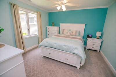 Brightly lit bedroom with light blue accents