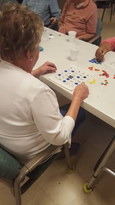 Residents playing bingo at a table