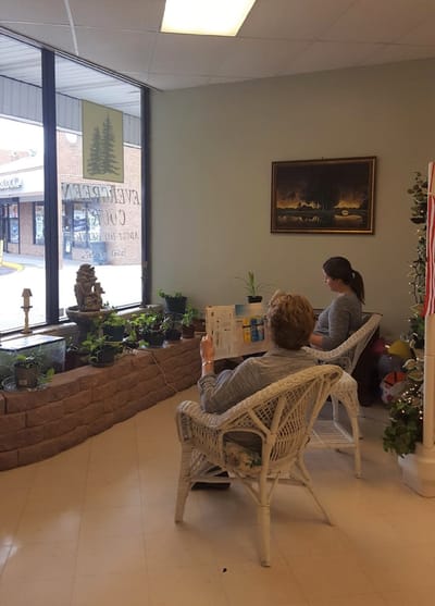 Residents relaxing in a common area with plants