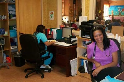Staff member smiling in a bright office area