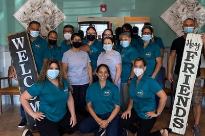 Staff members posing together in a welcoming atmosphere