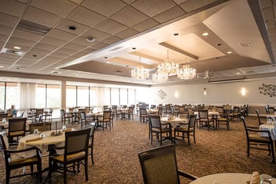 Interior view of the dining room with tables and chandeliers