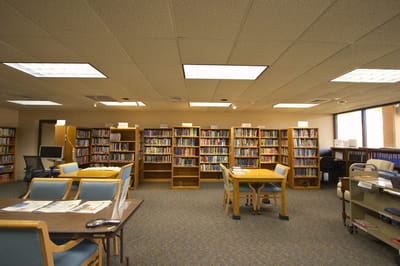 A library with shelves of books and study tables