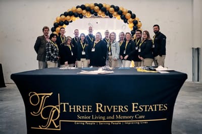 Staff posing in a common area for a group photo