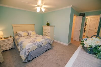 Cozy bedroom with a bed and dresser.