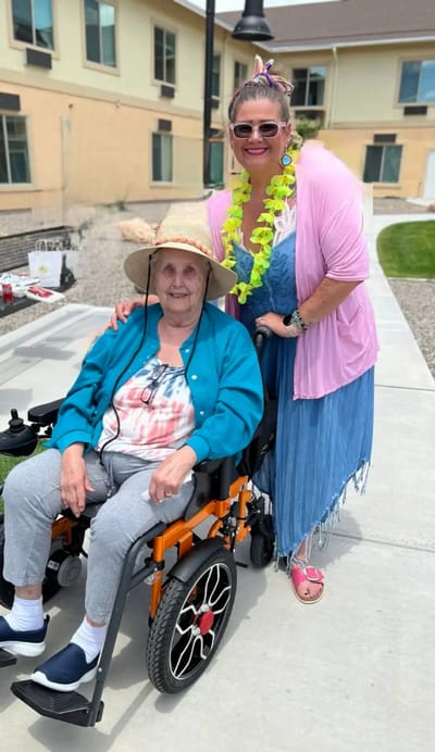 Residents enjoying a sunny day outside with staff member